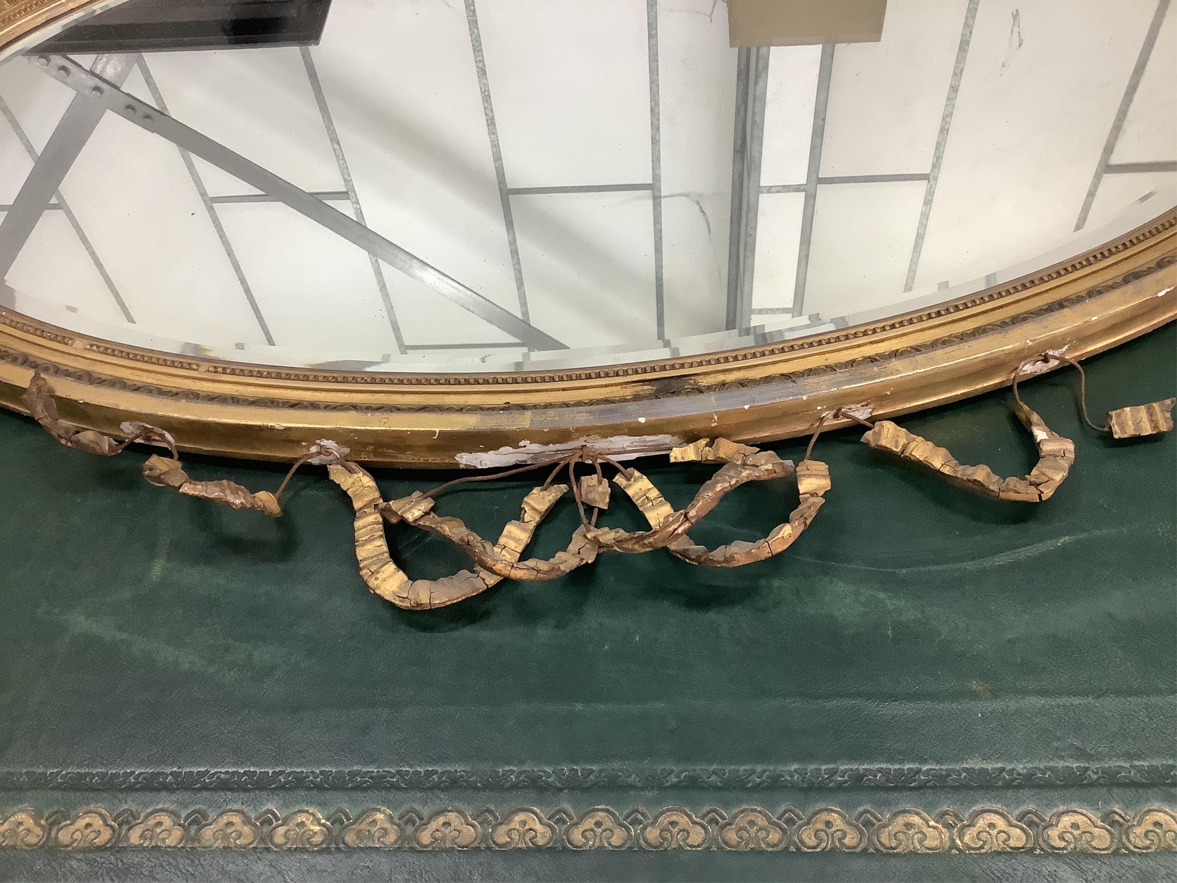 An early 20th century Adam Revival giltwood wall mirror, width 108cm, height 87cm. Condition - numerous losses